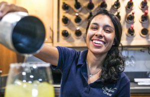 Hostess Marcella pours drinks at the bar