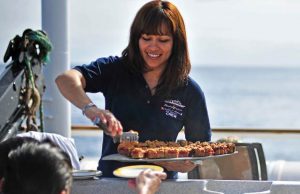 Hostess Sylvia serves treats to guests in the hot tub