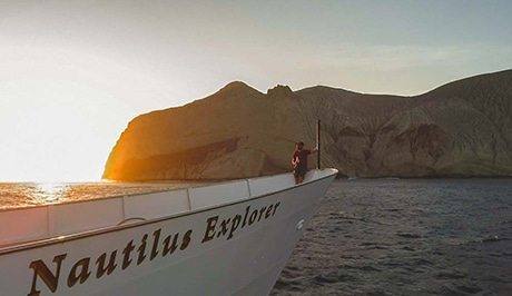 Nautilus explorer sails by san benedicto island's cinder cone